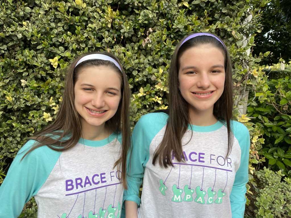 Hadley and Delany wearing Brace for Impact T's