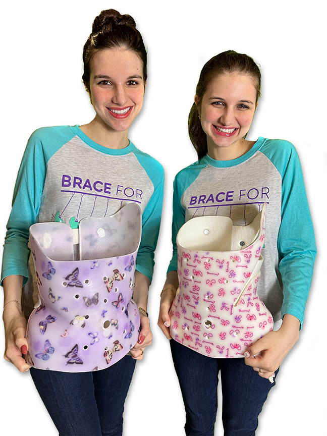 Hadley and Delaney pose holding decorative braces.